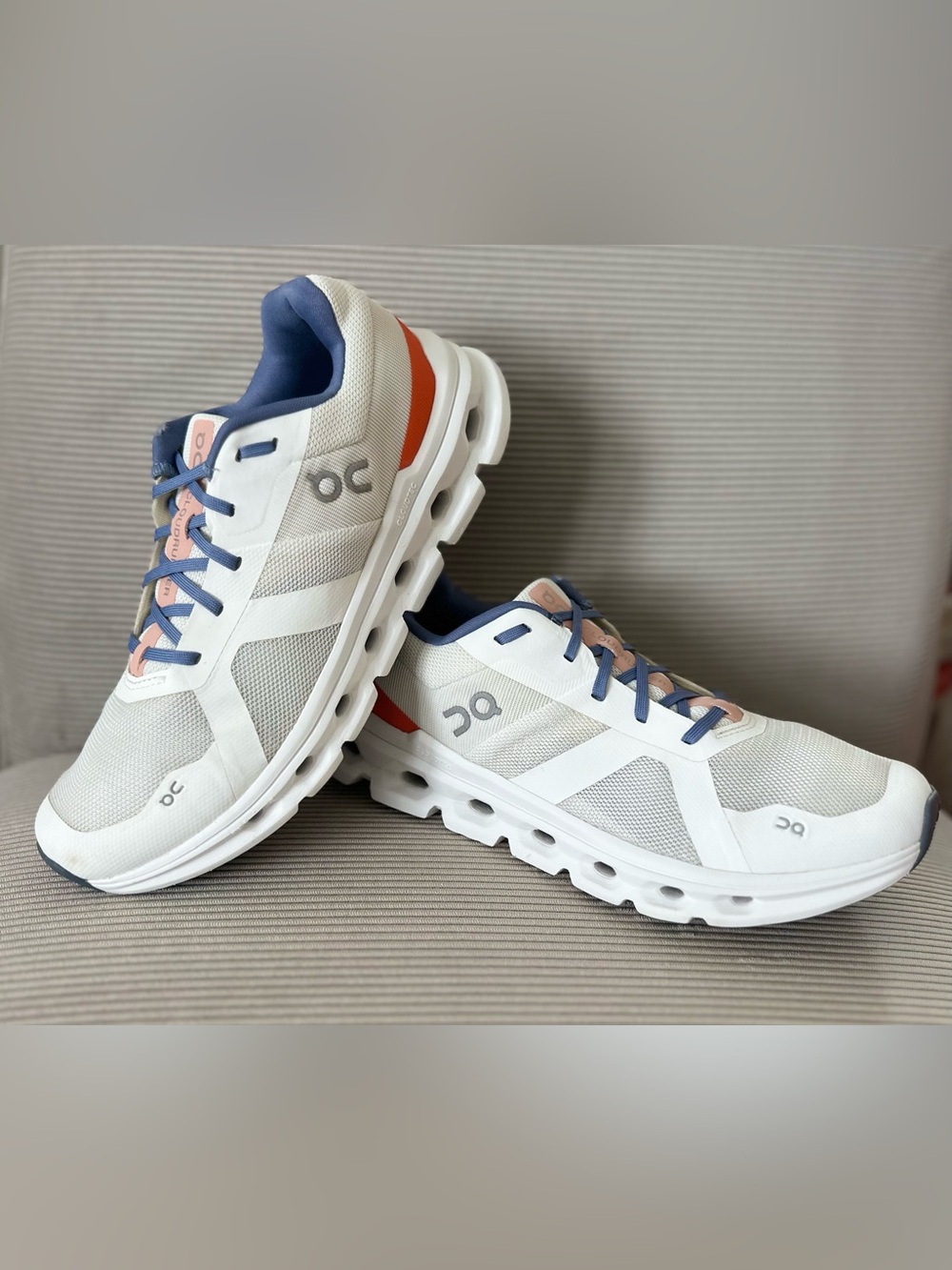 On Running Women’s Cloudrunner in the "Undyed White / Flame" size 9.5